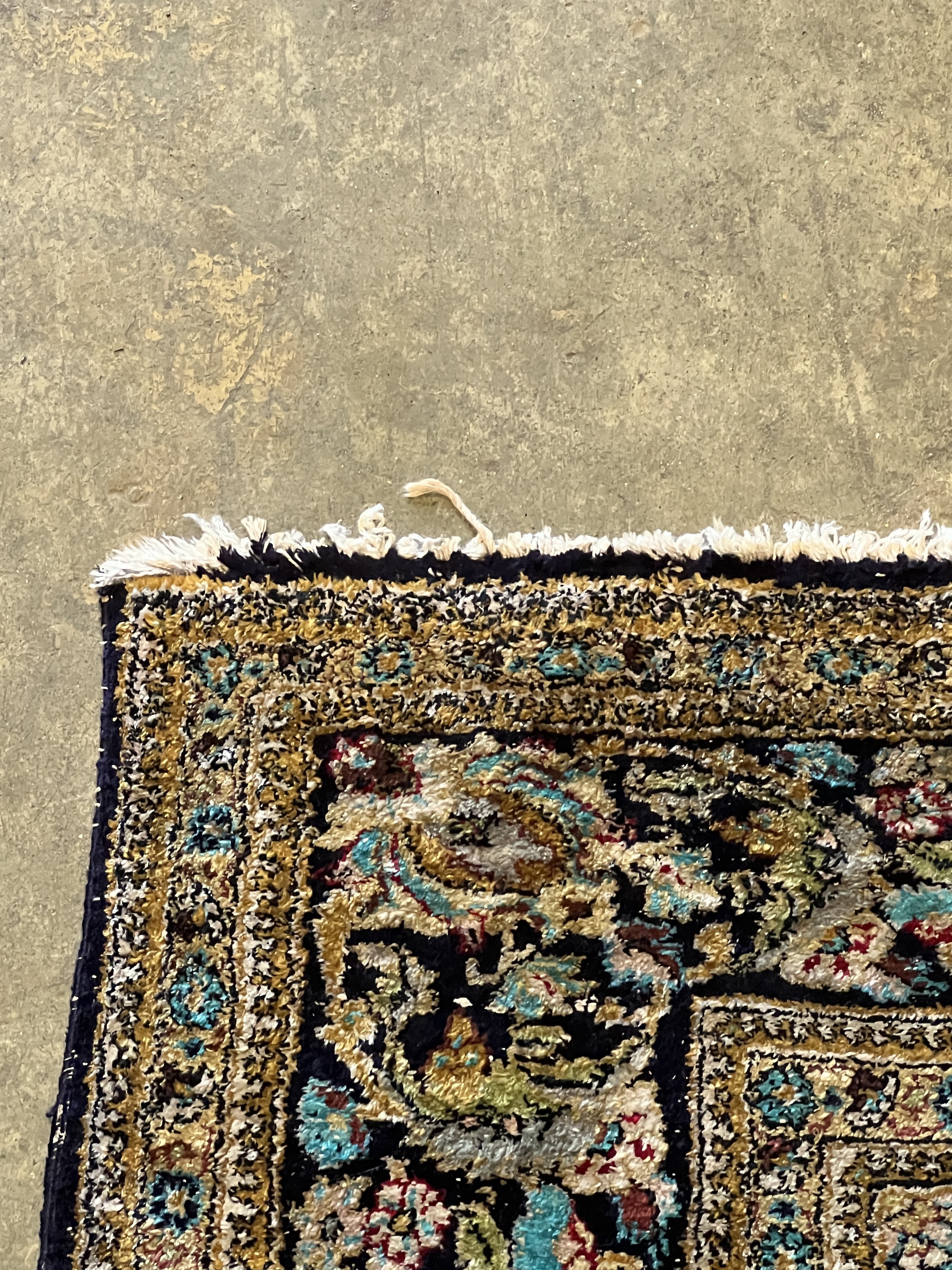 A Tabriz part silk burgundy ground rug, 218 x 150cm